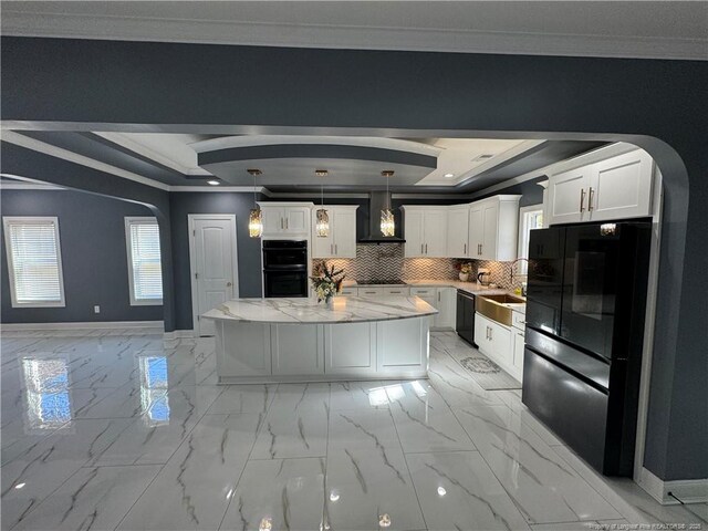 504 E Edinborough Ave, Raeford, NC 28376 - kitchen with a raised ceiling, arched walkways, wall chimney exhaust hood, black appliances, and ornamental molding