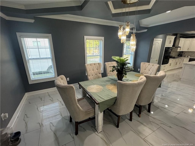 504 E Edinborough Ave, Raeford, NC 28376 - dining area featuring light marble finish floors, a chandelier, crown molding, baseboards, and arched walkways