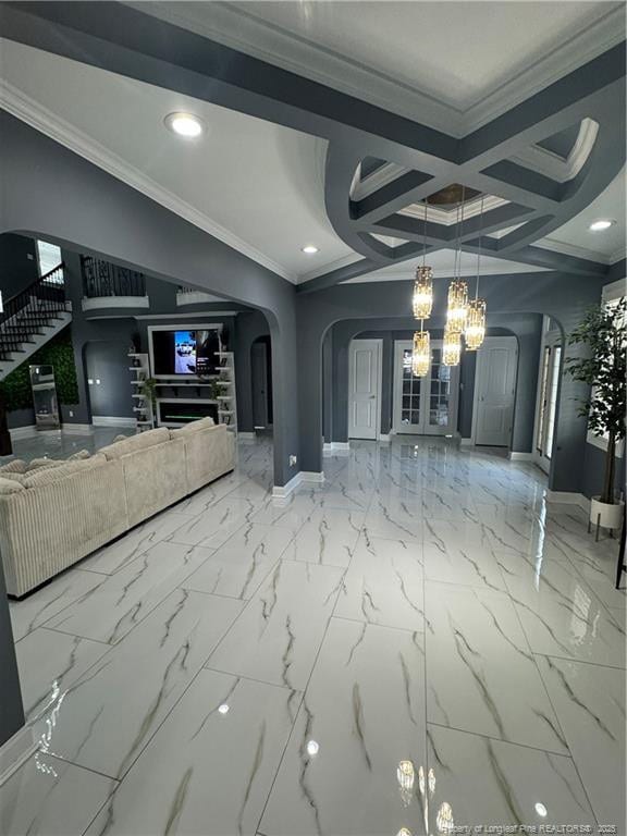 504 E Edinborough Ave, Raeford, NC 28376 - unfurnished living room featuring arched walkways, baseboards, a chandelier, coffered ceiling, and ornamental molding