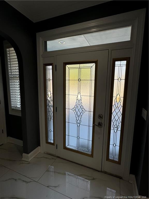 504 E Edinborough Ave, Raeford, NC 28376 - foyer featuring baseboards, light marble finish flooring, and arched walkways