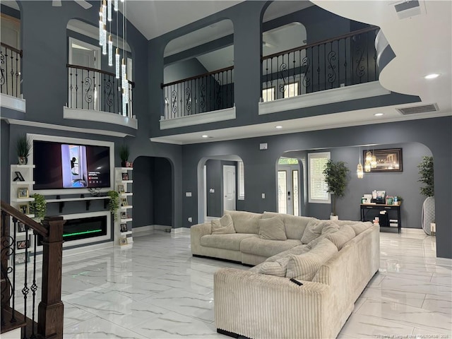504 E Edinborough Ave, Raeford, NC 28376 - living area featuring marble look tiles, arched walkways, baseboards, recessed lighting, and stairs