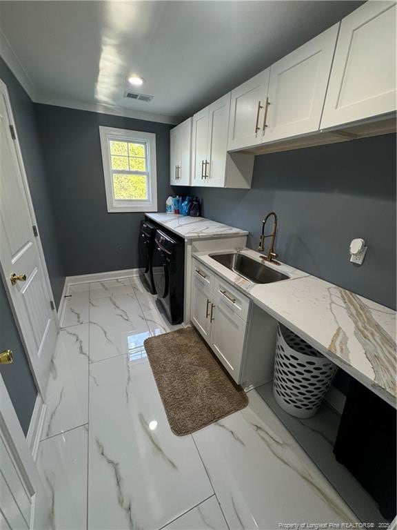 504 E Edinborough Ave, Raeford, NC 28376 - kitchen featuring washer and clothes dryer, a sink, light marble finish floors, baseboards, and ornamental molding