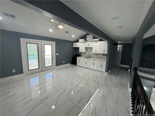 504 E Edinborough Ave, Raeford, NC 28376 - kitchen with light marble finish flooring, baseboards, a sink, crown molding, and vaulted ceiling