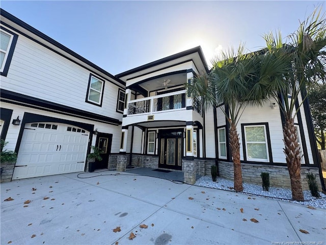 504 E Edinborough Ave, Raeford, NC 28376 - view of front of home featuring a balcony, stone siding, concrete driveway, and a garage