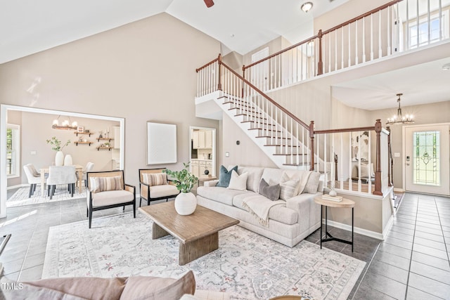1717 Ormond Rd, Hurdle Mills, NC 27541 - living area featuring a chandelier, high vaulted ceiling, tile patterned floors, stairs, and baseboards