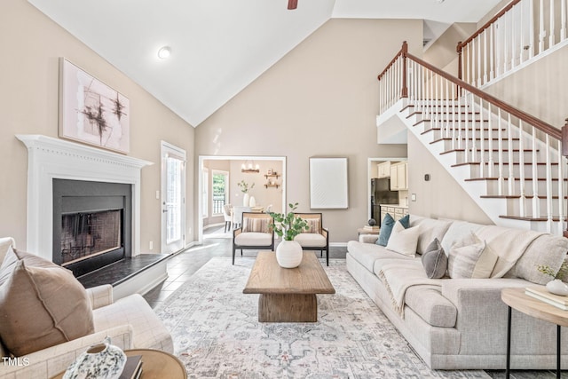 1717 Ormond Rd, Hurdle Mills, NC 27541 - living area featuring high vaulted ceiling, stairway, a fireplace with raised hearth, baseboards, and ceiling fan