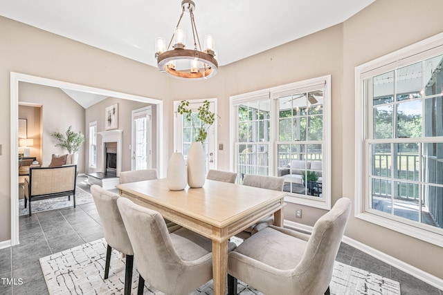 1717 Ormond Rd, Hurdle Mills, NC 27541 - dining area featuring a chandelier, baseboards, and a fireplace with raised hearth