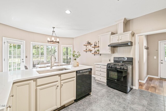 1717 Ormond Rd, Hurdle Mills, NC 27541 - kitchen featuring black appliances, a sink, under cabinet range hood, light countertops, and a chandelier