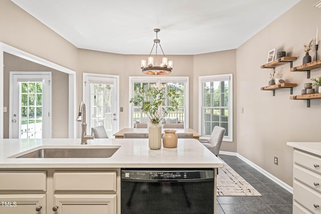 1717 Ormond Rd, Hurdle Mills, NC 27541 - kitchen featuring black dishwasher, a sink, light countertops, and a chandelier