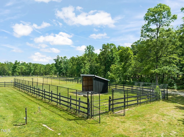 1717 Ormond Rd, Hurdle Mills, NC 27541 - view of green lawn featuring a view of countryside, an outbuilding, a gate, and an exterior structure