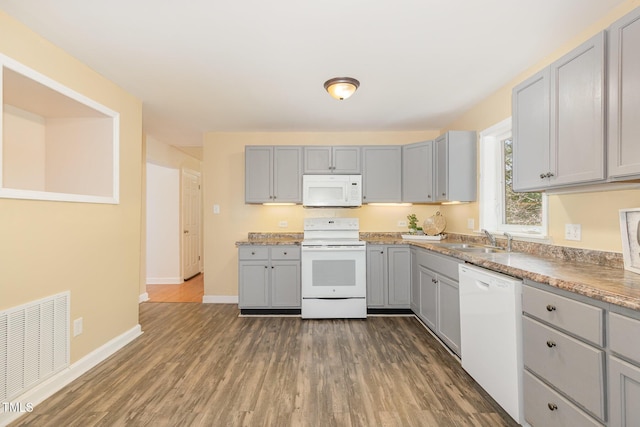408 N Stewart St, Clayton, NC 27520 - kitchen with white appliances, gray cabinets, and a sink