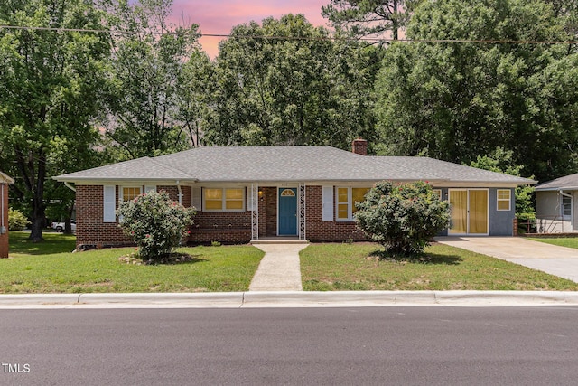 408 N Stewart St, Clayton, NC 27520 - ranch-style house with driveway, a chimney, brick siding, and a front lawn