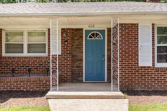 408 N Stewart St, Clayton, NC 27520 - doorway to property with brick siding, a shingled roof, a chimney, and a porch