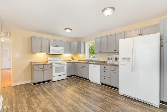 408 N Stewart St, Clayton, NC 27520 - kitchen featuring white appliances, gray cabinetry, dark wood finished floors, baseboards, and a sink