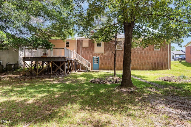 408 N Stewart St, Clayton, NC 27520 - back of house featuring brick siding, a wooden deck, a lawn, and stairs