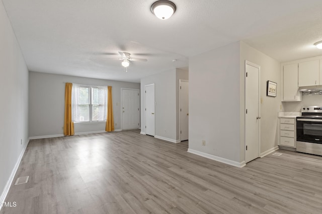 unfurnished living room featuring light wood finished floors, a ceiling fan, and baseboards