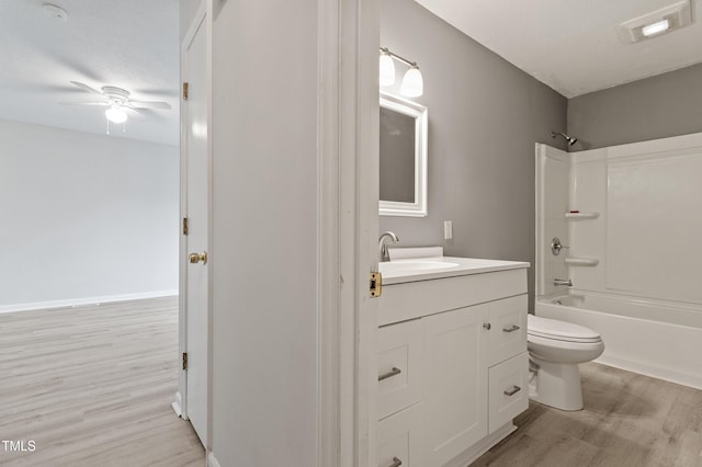 full bathroom with wood finished floors, toilet, a ceiling fan, and vanity