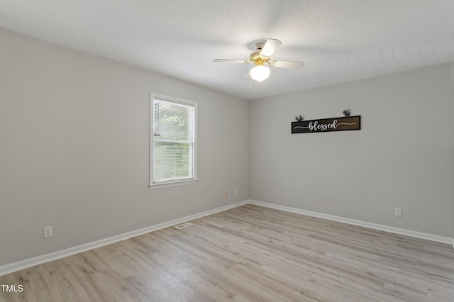 empty room featuring light wood-style floors, ceiling fan, and baseboards