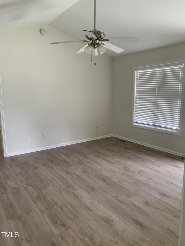 2001 Ballston Pl, Knightdale, NC 27545 - empty room with a ceiling fan, wood finished floors, baseboards, and lofted ceiling