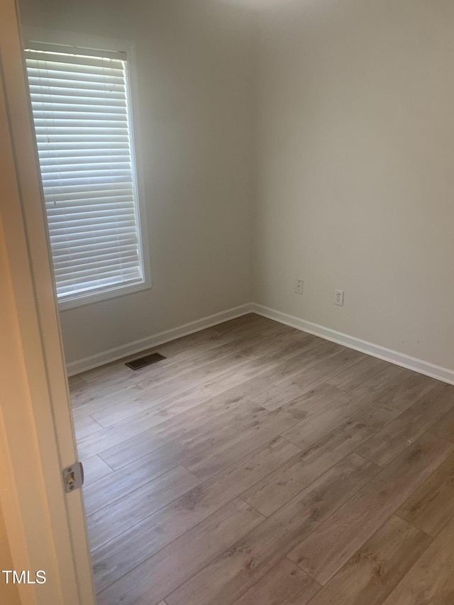 2001 Ballston Pl, Knightdale, NC 27545 - unfurnished room featuring wood finished floors, baseboards, and plenty of natural light