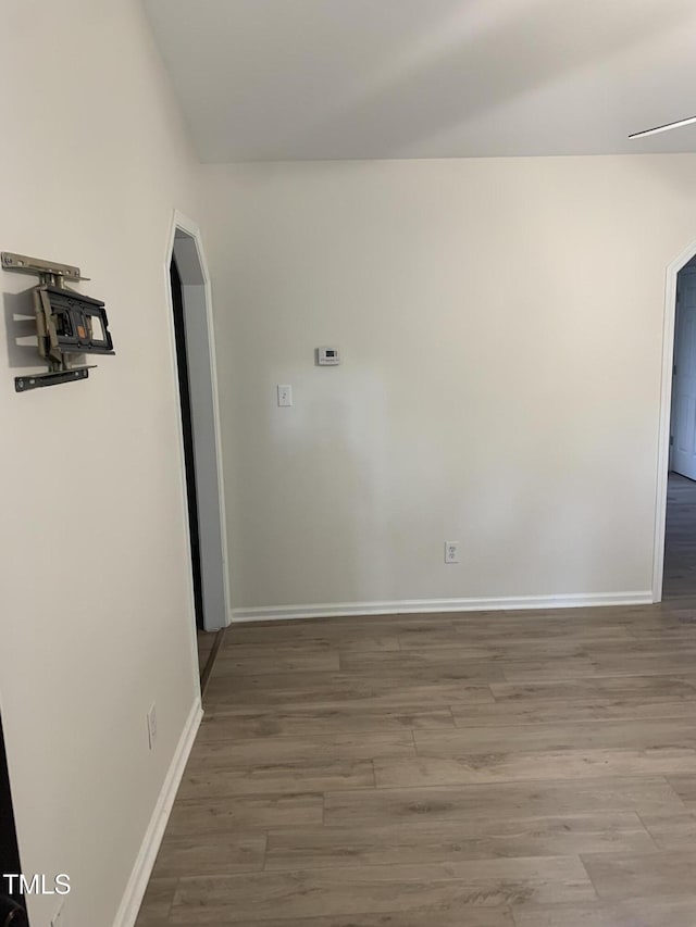 2001 Ballston Pl, Knightdale, NC 27545 - unfurnished room featuring wood finished floors, baseboards, and arched walkways