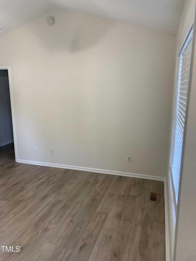 2001 Ballston Pl, Knightdale, NC 27545 - empty room featuring wood finished floors, lofted ceiling, and plenty of natural light