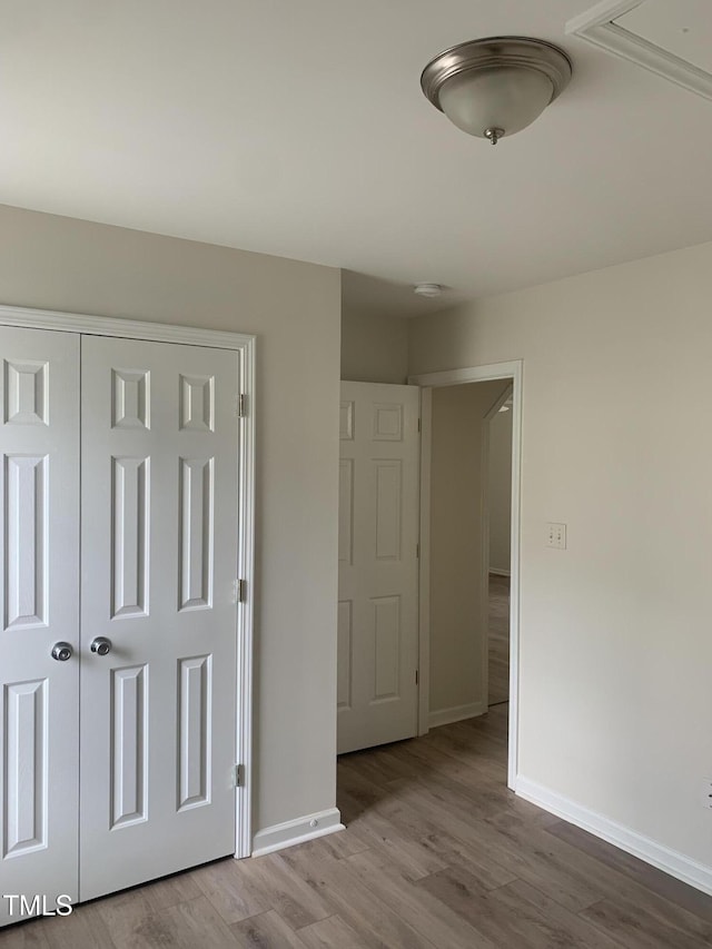 2001 Ballston Pl, Knightdale, NC 27545 - unfurnished bedroom featuring wood finished floors, baseboards, and a closet