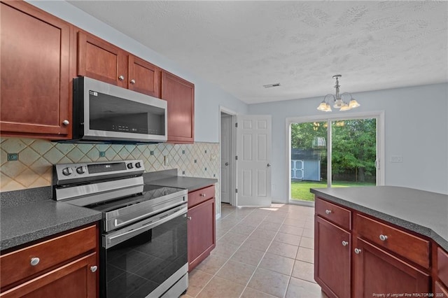 11 Checkmate Ct, Cameron, NC 28326 - kitchen with stainless steel appliances, dark countertops, a chandelier, decorative backsplash, and hanging light fixtures