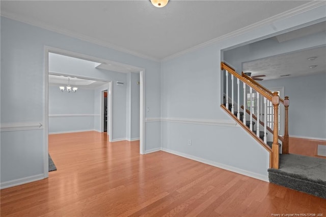 11 Checkmate Ct, Cameron, NC 28326 - spare room featuring wood finished floors, stairs, a chandelier, crown molding, and baseboards