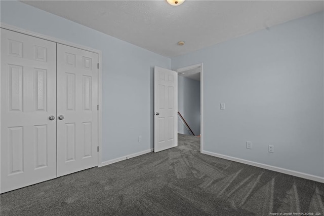 11 Checkmate Ct, Cameron, NC 28326 - unfurnished bedroom with dark colored carpet, baseboards, and a closet