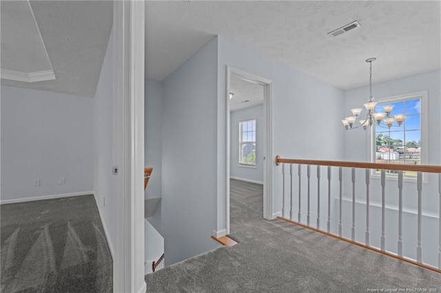 11 Checkmate Ct, Cameron, NC 28326 - hall with an upstairs landing, carpet flooring, a textured ceiling, a chandelier, and baseboards