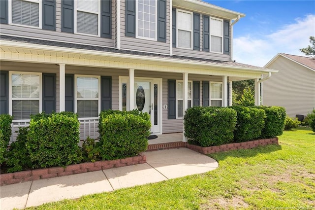 11 Checkmate Ct, Cameron, NC 28326 - view of exterior entry featuring a porch and a yard