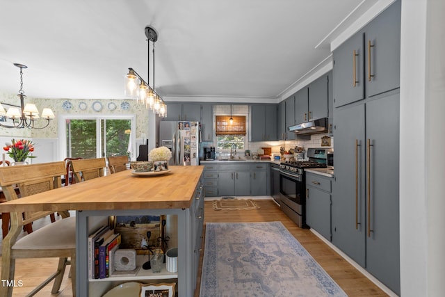 3620 Arrowwood Dr, Raleigh, NC 27604 - kitchen featuring stainless steel appliances, gray cabinets, under cabinet range hood, wood counters, and a chandelier