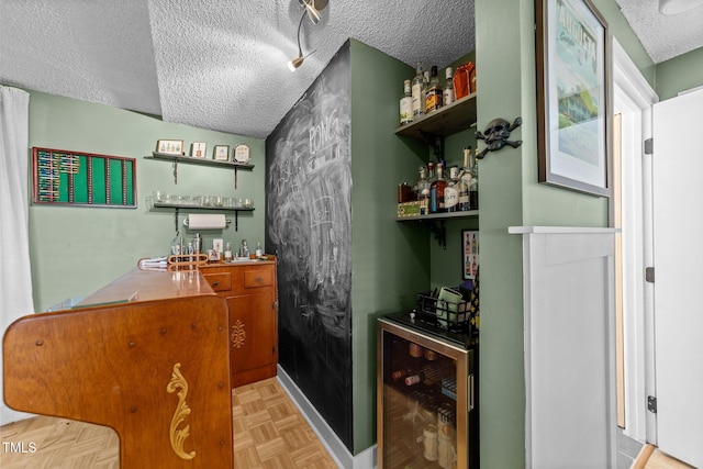 3620 Arrowwood Dr, Raleigh, NC 27604 - indoor wet bar with wine cooler, a textured ceiling, and baseboards
