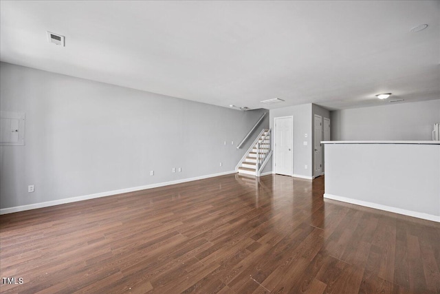 8630 Neuse Lndg Unit 105, Raleigh, NC 27616 - unfurnished living room with baseboards, wood finished floors, and stairway