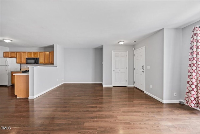 8630 Neuse Lndg Unit 105, Raleigh, NC 27616 - unfurnished living room featuring dark wood-style flooring and baseboards
