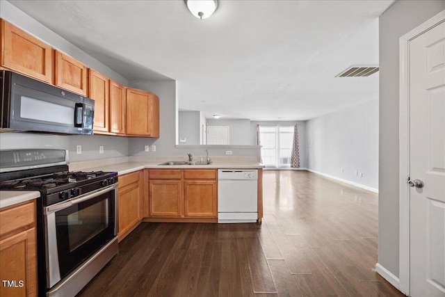 8630 Neuse Lndg Unit 105, Raleigh, NC 27616 - kitchen featuring white dishwasher, black microwave, stainless steel range with gas stovetop, a sink, and dark wood-style flooring