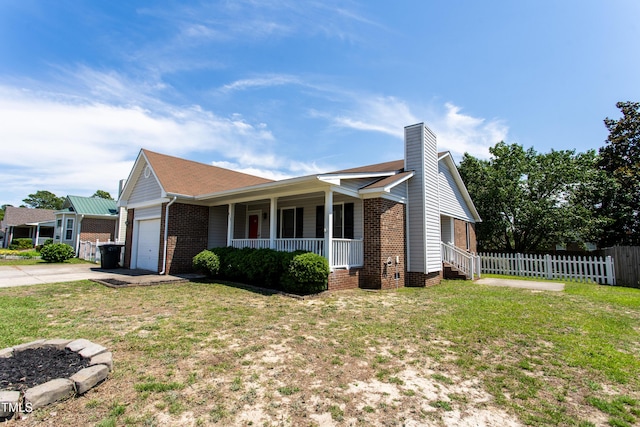 613 Sunnybrook Dr, Hope Mills, NC 28348 - view of front facade featuring a porch, a garage, brick siding, driveway, and a chimney