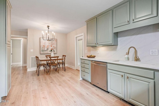 847 E Maple Ln, Fuquay Varina, NC 27526 - kitchen featuring stainless steel dishwasher, light wood-style flooring, a sink, and a chandelier