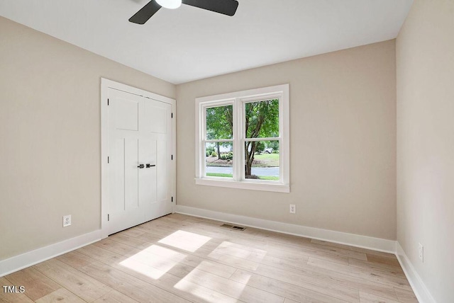 847 E Maple Ln, Fuquay Varina, NC 27526 - unfurnished bedroom featuring baseboards, light wood finished floors, and a closet