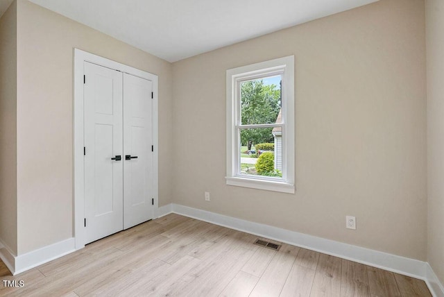 847 E Maple Ln, Fuquay Varina, NC 27526 - unfurnished bedroom featuring light wood-type flooring, baseboards, and a closet