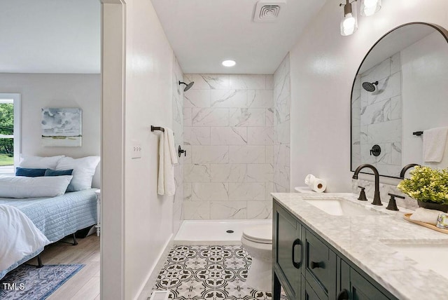 847 E Maple Ln, Fuquay Varina, NC 27526 - full bathroom featuring a tile shower, toilet, double vanity, and baseboards