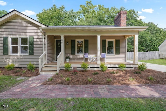 847 E Maple Ln, Fuquay Varina, NC 27526 - view of front facade featuring covered porch and a chimney