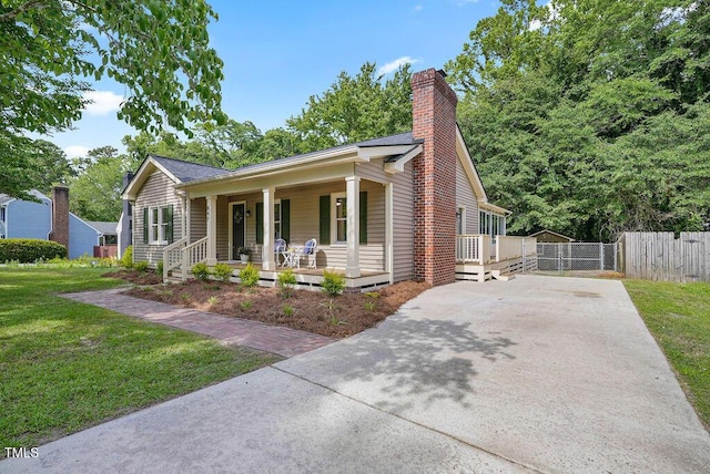 847 E Maple Ln, Fuquay Varina, NC 27526 - ranch-style home featuring driveway, covered porch, and a chimney