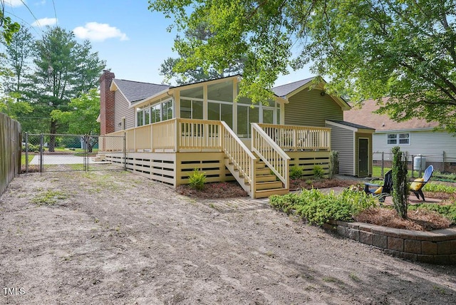 847 E Maple Ln, Fuquay Varina, NC 27526 - view of front of house with a sunroom, a wooden deck, and a gate