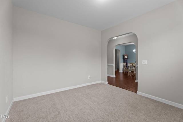 30 Sunbury Ct, Zebulon, NC 27597 - spare room with carpet, arched walkways, and baseboards