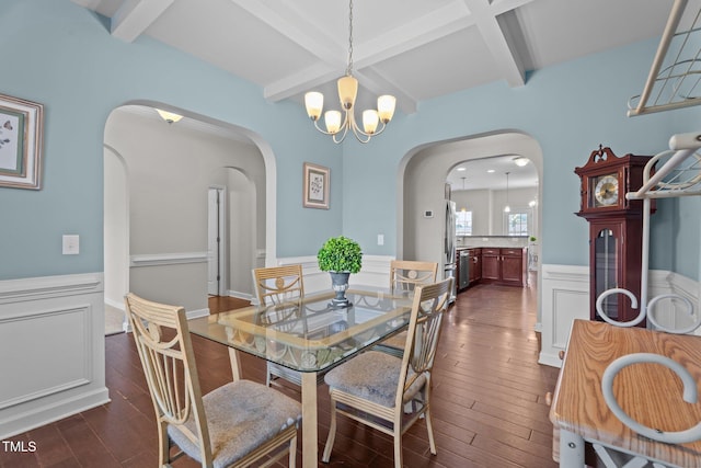 30 Sunbury Ct, Zebulon, NC 27597 - dining area with arched walkways, a wainscoted wall, dark wood-style flooring, beam ceiling, and a chandelier