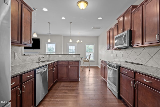 30 Sunbury Ct, Zebulon, NC 27597 - kitchen featuring appliances with stainless steel finishes, a sink, dark wood-style flooring, light stone counters, and recessed lighting