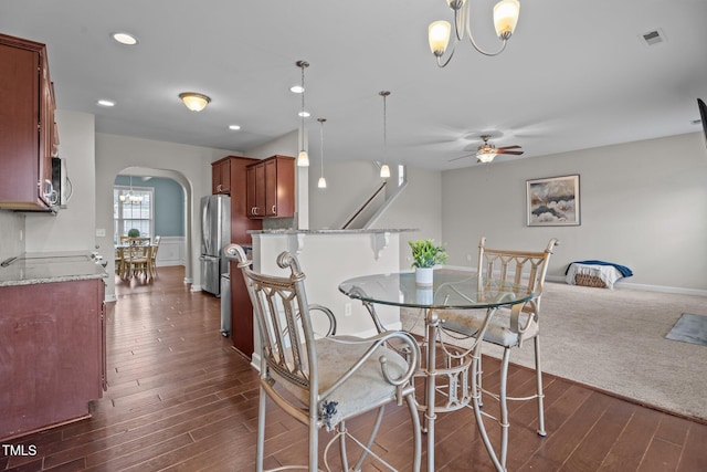 30 Sunbury Ct, Zebulon, NC 27597 - dining space featuring arched walkways, ceiling fan, dark wood finished floors, recessed lighting, and a chandelier