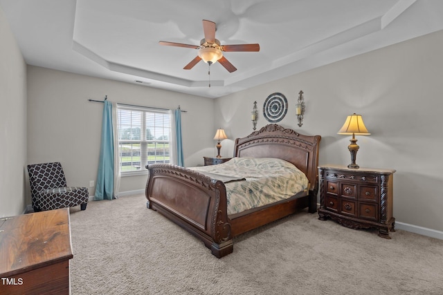 30 Sunbury Ct, Zebulon, NC 27597 - bedroom featuring a tray ceiling, carpet floors, baseboards, and ceiling fan